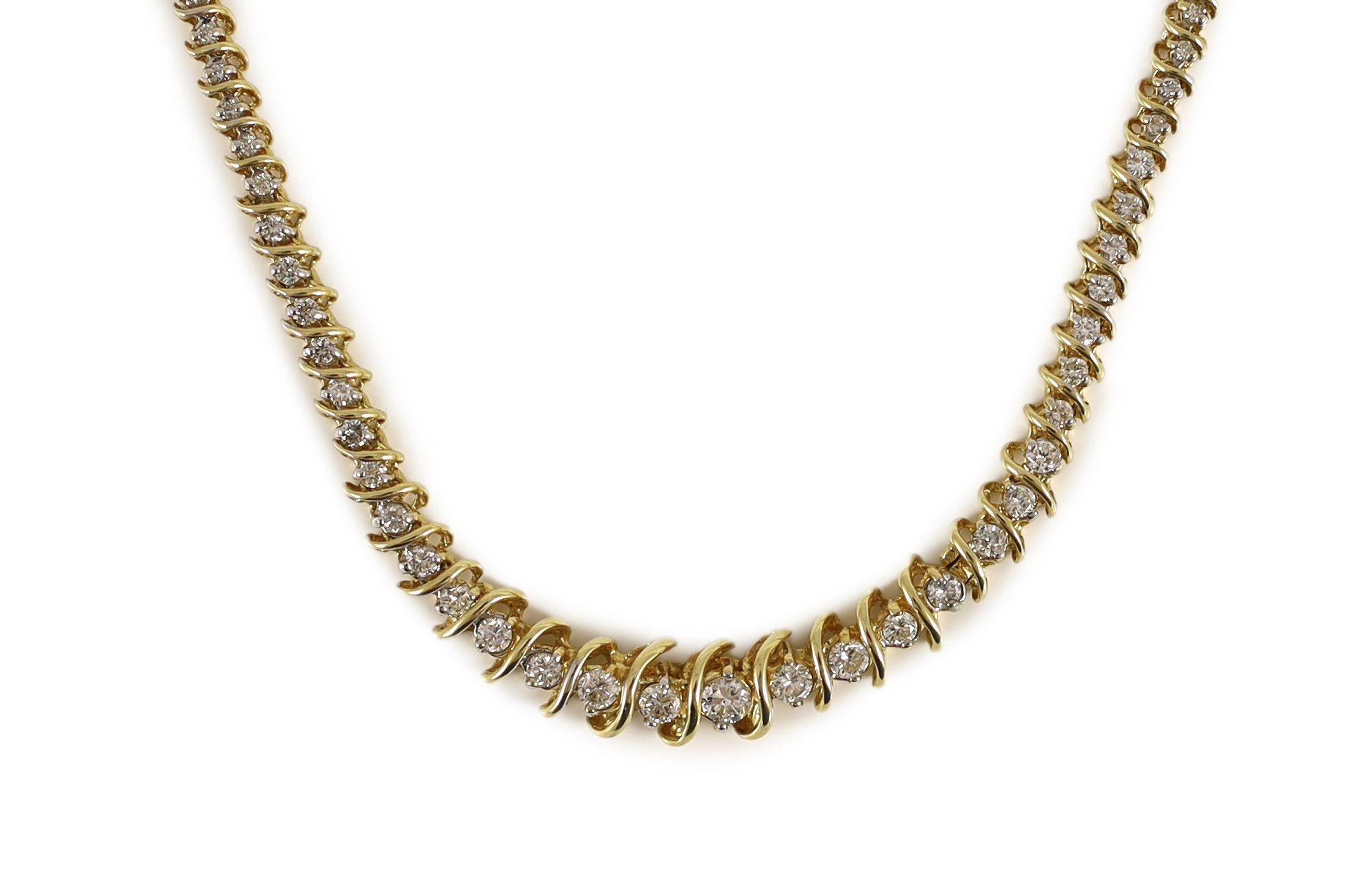 A modern 14k gold and graduated diamond set shaped line necklace